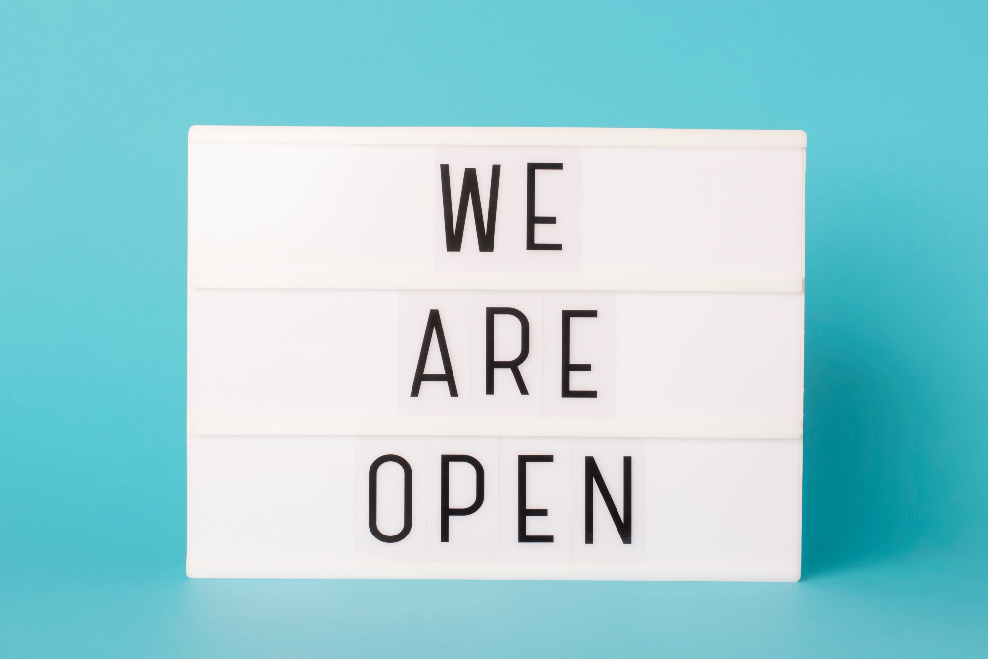 Rear view of a father and son bonding while they sit on a pier by a lake with copyspace