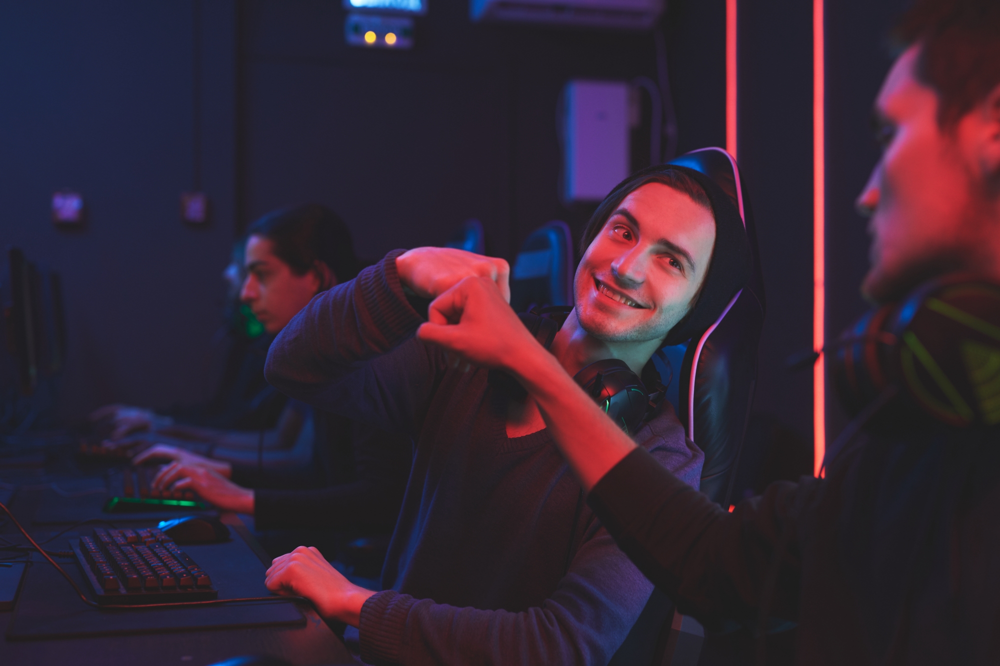 Rear view of a father and son bonding while they sit on a pier by a lake with copyspace