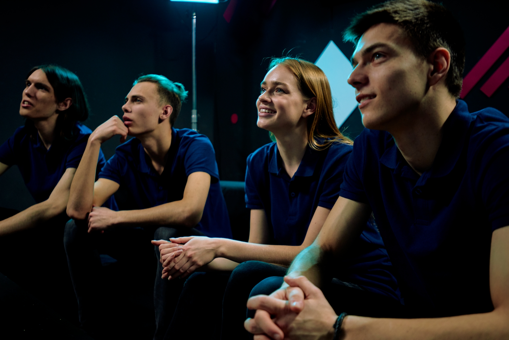 Rear view of a father and son bonding while they sit on a pier by a lake with copyspace